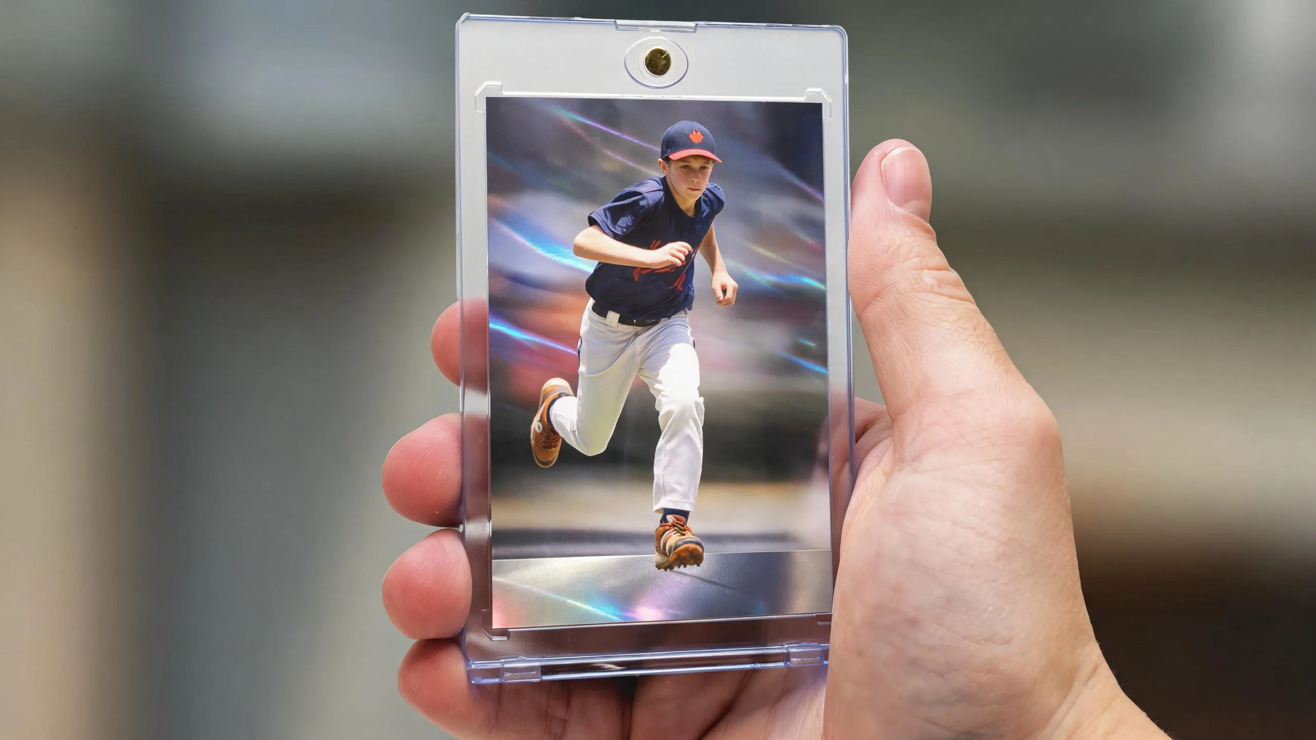 Hand holds magnetic case with blank-foil athlete card, honoring athletes who died young.