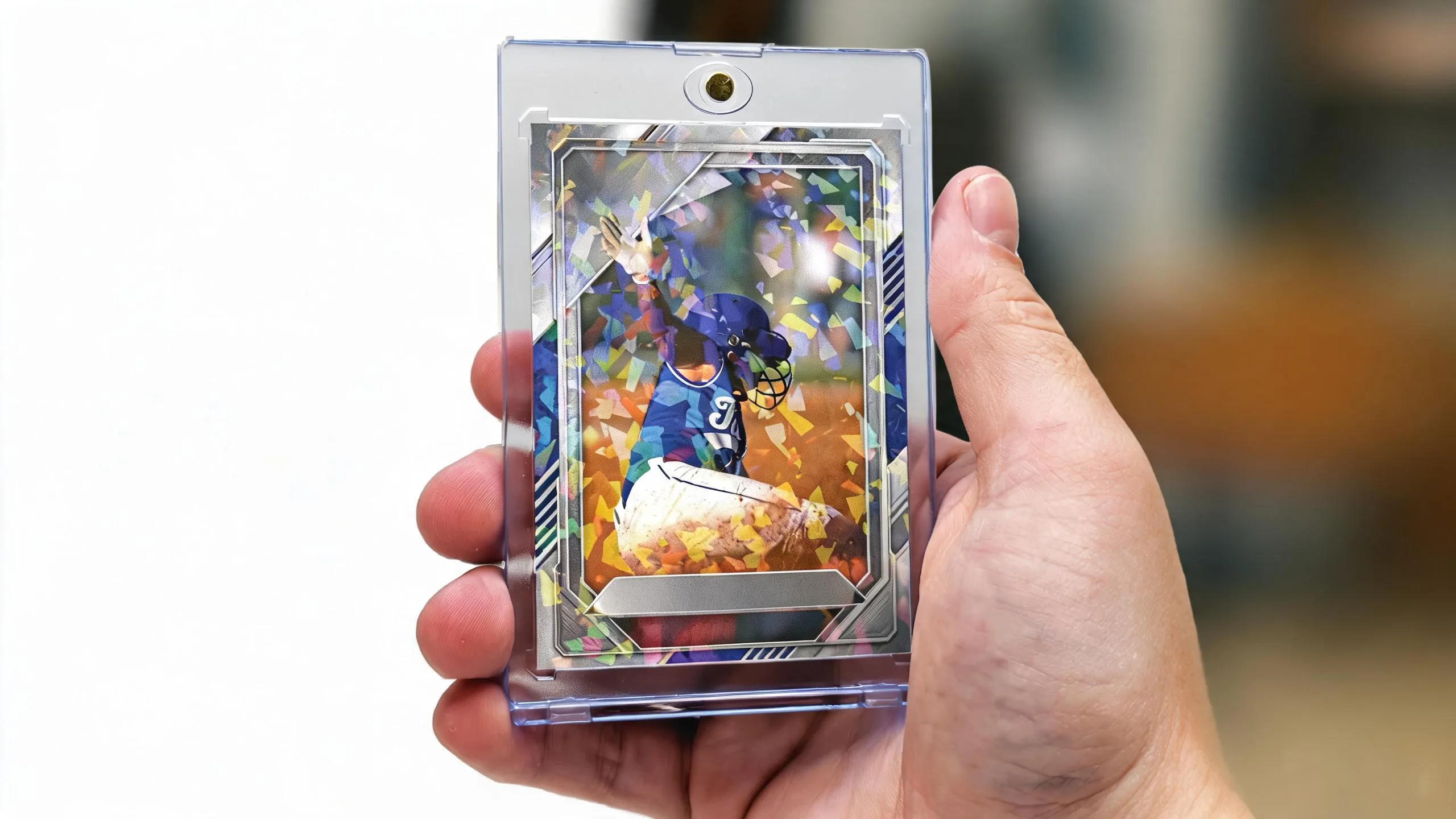 Hand holding custom sports cards in a magnetic case with a golden-hour action portrait design.