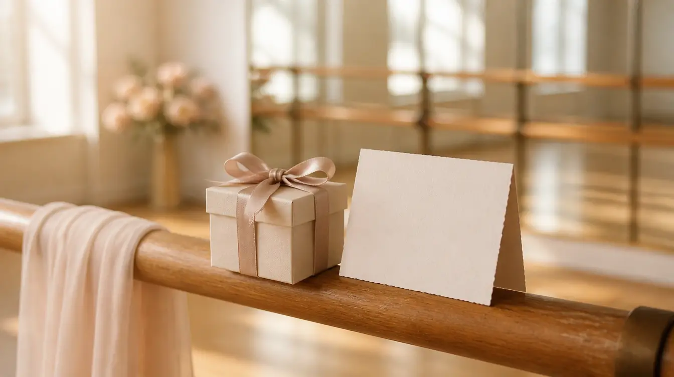 An elegant gift box and a blank card resting on a ballet barre in a bright dance studio