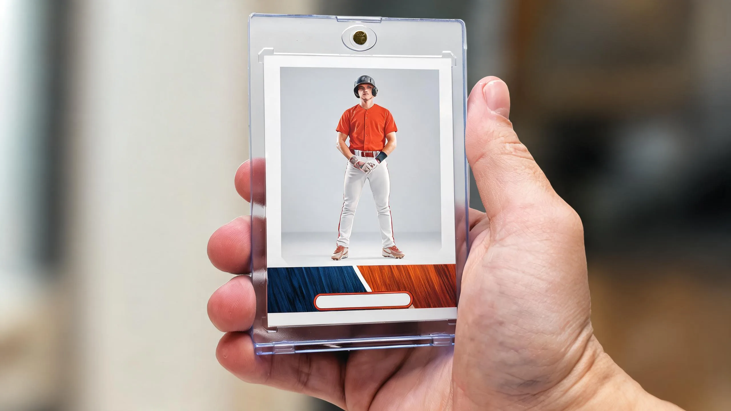Hand holds a magnetic case with a custom kids sports card — make sports cards for kids, keepsake gift.