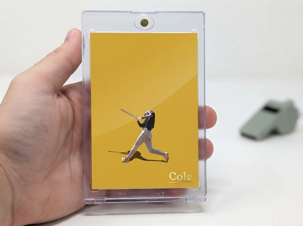 Magnetic case holding minimalist yellow custom sports trading card with foil nameplate.