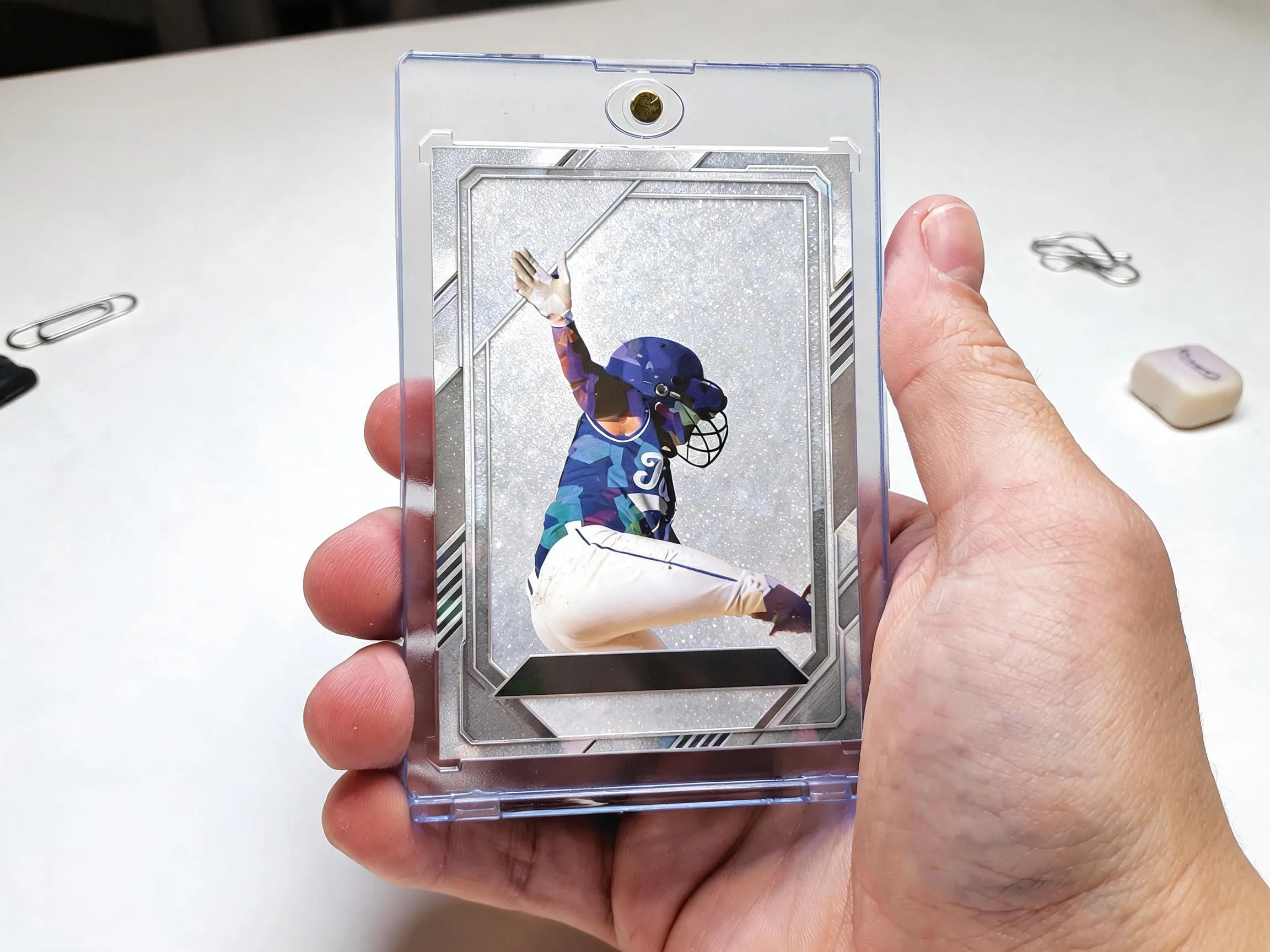 Custom keepsake trading card in magnetic case displayed on white tabletop.