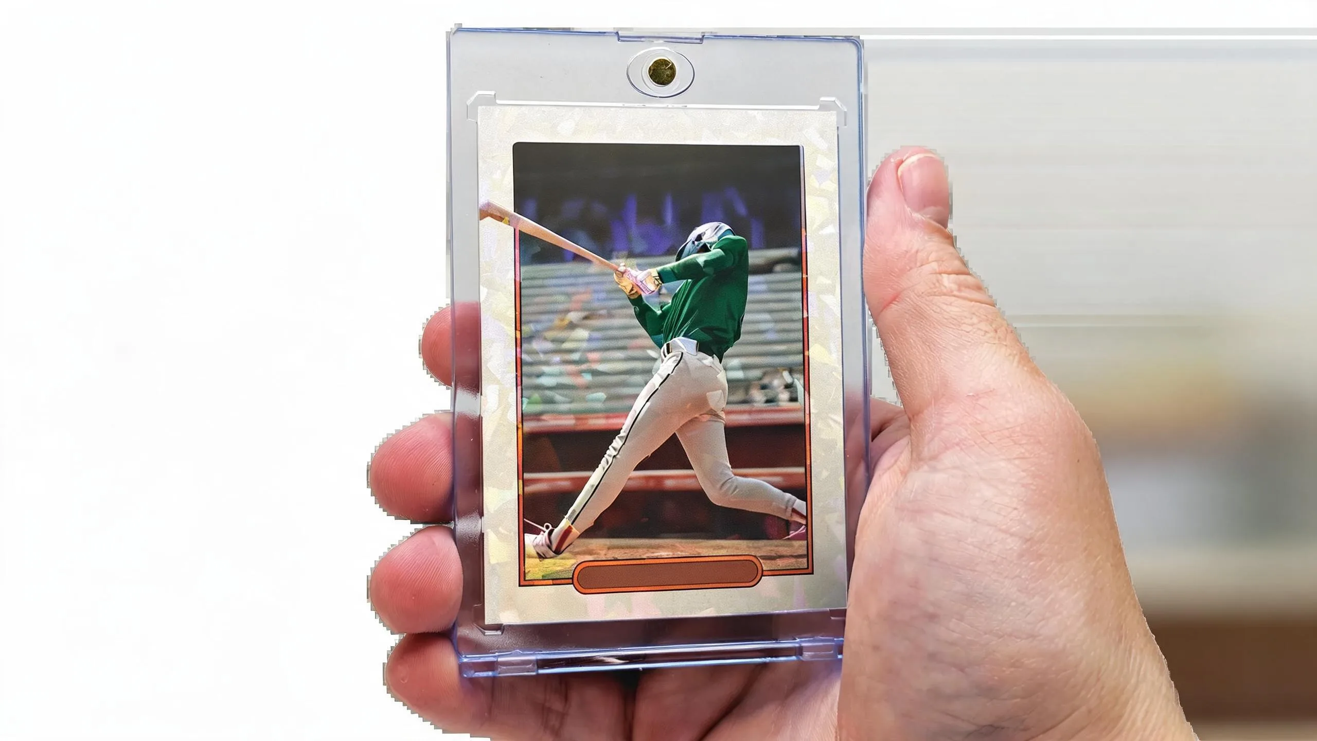 Hand holding magnetic case with athlete card, illustrating standard playing card dimensions clearly.