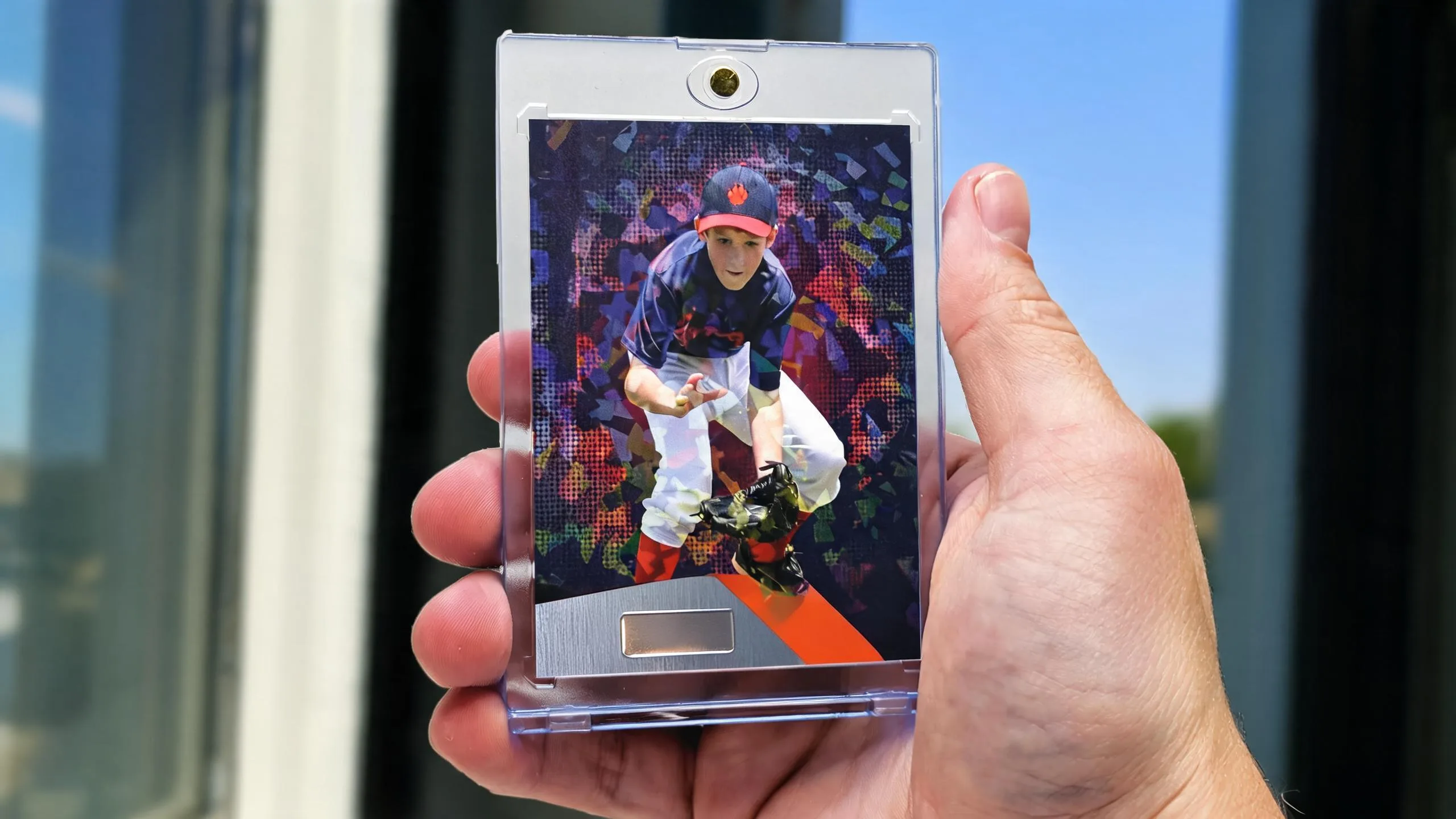 Hand holding magnetic case with young athlete card, symbolizing strength and conditioning training for young athletes.